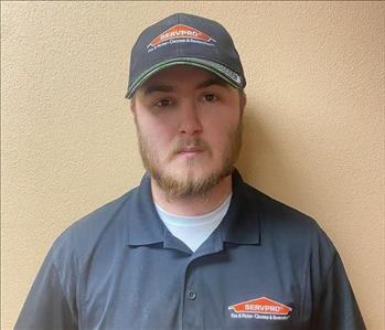white male in a black SERVPRO polo