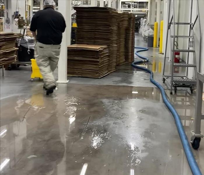 Concrete floor with puddles of water on it
